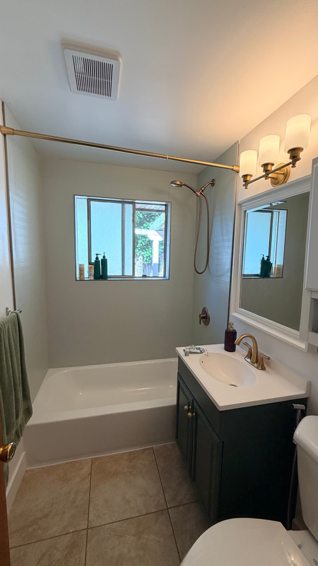 Guest bathroom before and after a sage and brass update — after